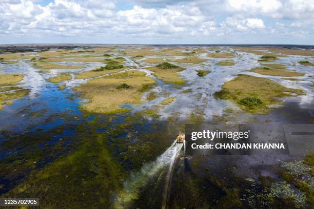 Airboat is seen hovering over Everglades wetland in Everglades wetlands in Everglades National Park, Florida on September 30, 2021. - The largest...