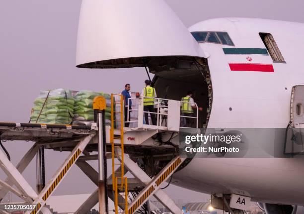 Irans humanitarian supplies are loaded into an Iranian Qeshm Fars Airlines Boeing 747-200 cargo plane to Afghanistan for helping Afghan poor people,...
