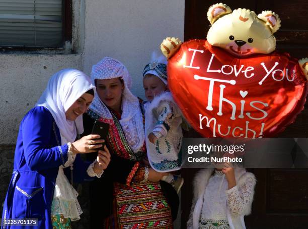 Woman holds her son during traditional circumcision ritual in Rhodope Mountain village of Ribnovo, Bulgaria on 03 October, 2021. Pomaks perform a...