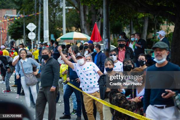 People of La Perseverancia neighborhood support cyclists during the last stage finals of the Vuelta a Colombia Femenina 2021 in Bogotá, Colombia,...