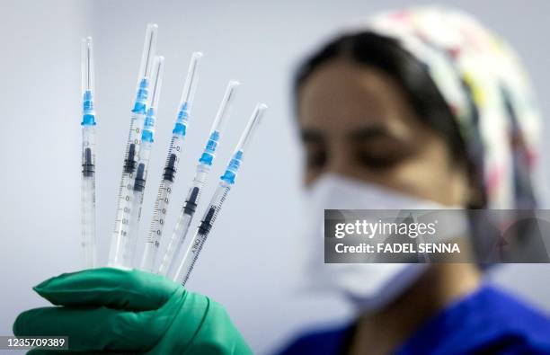 Moroccan health shows syringes of the Pfizer-BioNTech at a Covid-19 vaccination centre, in the city of Sale, on October 5, 2021.