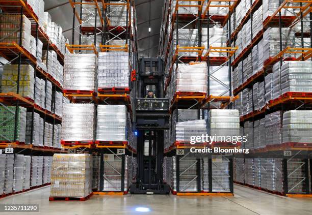 Worker stacks pallets of drinks at the Refresco soft-drink bottling factory in Kegworth, U.K., on Tuesday, Oct. 5, 2021. PAI Partners is considering...