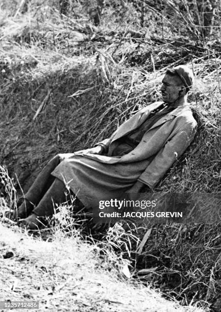 An Algerian rebel, wounded by three bullets and wearing military uniform, waits to be questioned on October 12 after a clash at Fort de l'Eau, during...