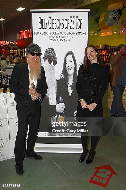 Musician/vocalist Billy Gibbons of ZZ Top and his wife Gilligan Gibbons pose after a signing of Pura Vida Tequila at Gabriel's Liquor on January 28,...
