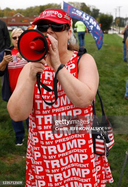 Susan Deur joins demonstrators protesting the visit of US President Joe Biden to Howell, Michigan, on October 5, 2021. - Biden visits Howell to speak...