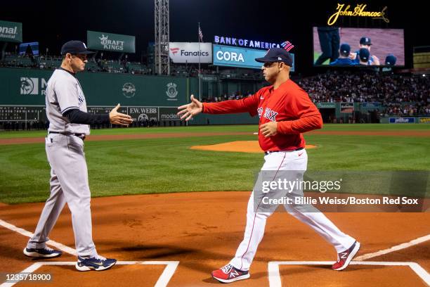 Manager Aaron Boone of the New York Yankees shakes hands with Manager Alex Cora of the Boston Red Sox as starting lineups are introduced during a...