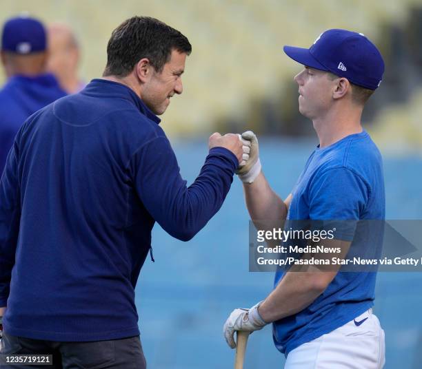 Los Angeles, CA Andrew Friedman, left, President of Baseball Operations fist pumps Will Smith of the Los Angeles Dodgers during a workout day before...
