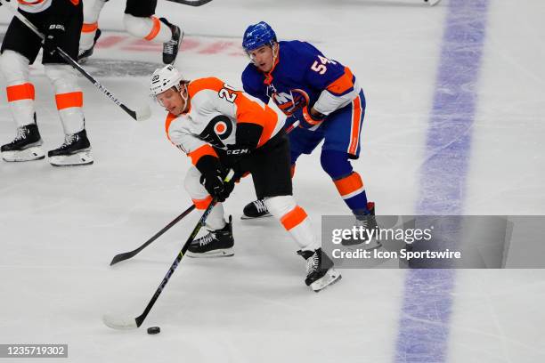 Philadelphia Flyers Center Gerald Mayhew and New York Islanders Center Cole Bardreau battle for the puck during the first period of the pre-season...