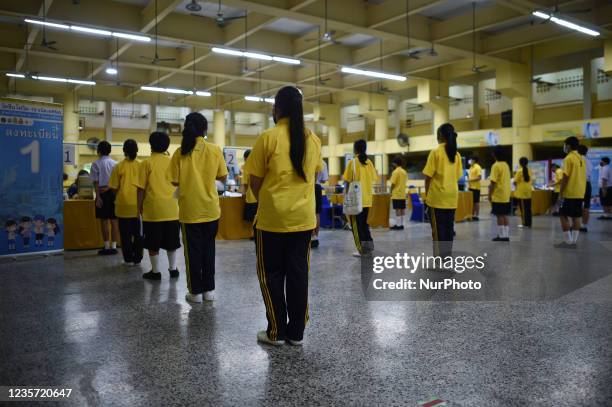 Thai student wait to be administered a dose of the Pfizer vaccine for the Covid-19 coronavirus at Surasak Montree School in Bangkok on October 6,...