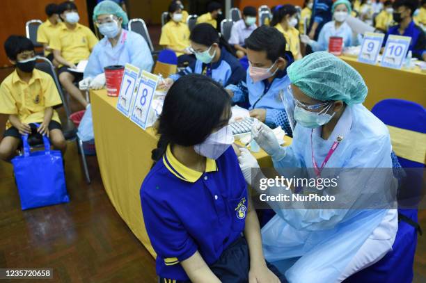 Thai student receives a dose of Pfizer vaccine during the initiation of a COVID-19 vaccination drive for students at Surasak Montree School in...