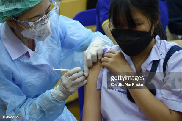 Thai student receives a dose of Pfizer vaccine during the initiation of a COVID-19 vaccination drive for students at Surasak Montree School in...
