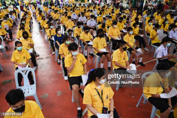 Thai student wait to be administered a dose of the Pfizer vaccine for the Covid-19 coronavirus at Surasak Montree School in Bangkok on October 6,...