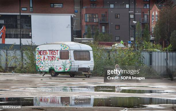 Caravan hand-painted with an anti-government slogan seen during the demonstration. Gypsies set up a camp on the outskirts of Manchester before...