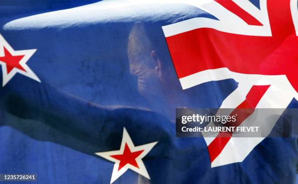 New Zealand's Tony Sargusson holds his national flag following the men's 50-km walk final at the Commonwealth Games in Melbourne, 24 March 2006....