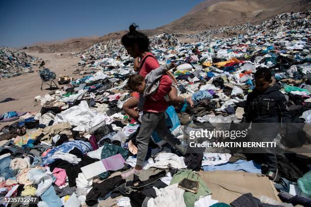 Venezuelan migrant searches a rubbish dump for clothes for her and her children in the Alto Hospicio area, on the outskirts of Iquique, Chile, on...