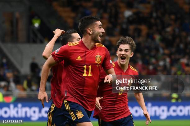 Spain's forward Ferran Torres celebrates with teammates after scoring a goal during the UEFA Nations League semifinal football match between Italy...