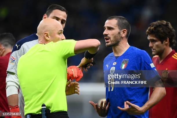 Italy's defender Leonardo Bonucci argues with Russian referee Sergei Karasev after receiving a red card during the UEFA Nations League semifinal...