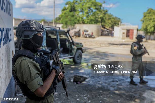 Haitian soldiers guard the Public Prosecutor's office as Martine Moïse is interviewed as a witness by the judge who is investigating the...