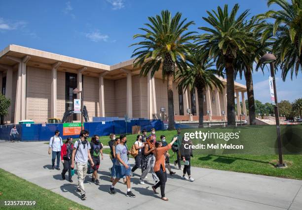 Michelle Street, foreground, right, an instructor for transfer success seminar, gives a tour of the campus to transfer students in their first...