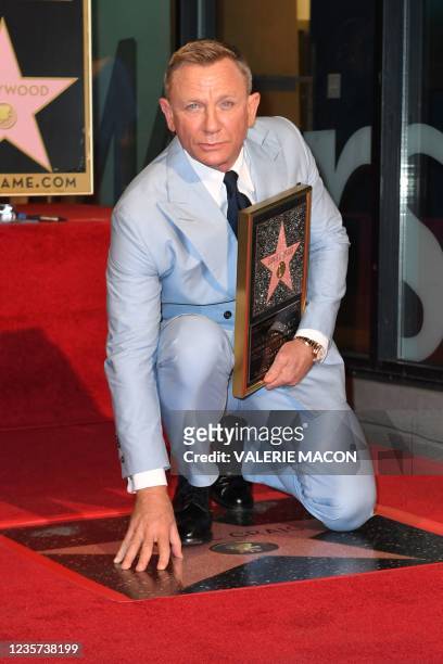British actor Daniel Craig poses with his star during the ceremony to honor him with a star on the Hollywood Walk of Fame in Los Angeles, California,...