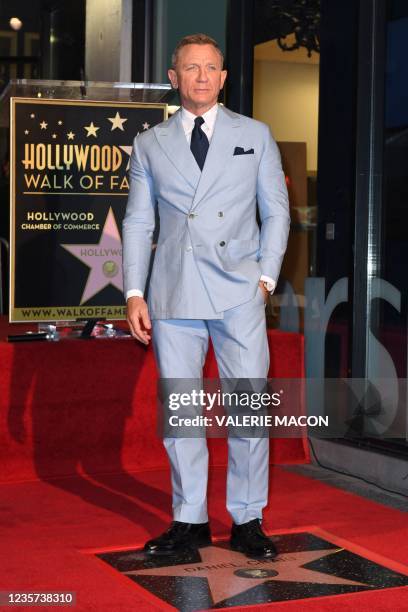 British actor Daniel Craig poses with his star during the ceremony to honor him with a star on the Hollywood Walk of Fame in Los Angeles, California,...