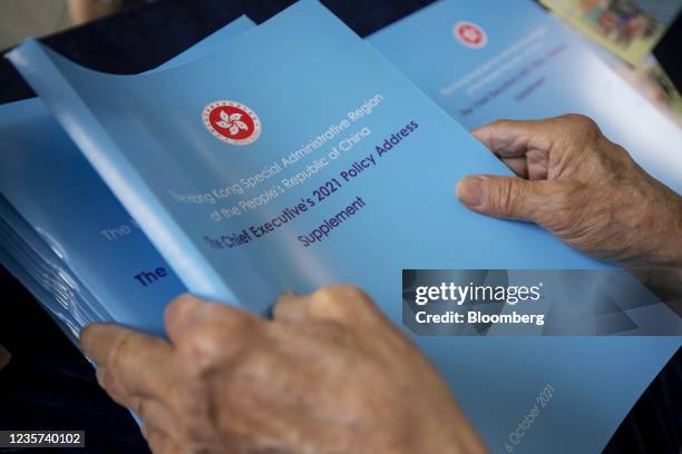 Copies of the policy address supplement by Hong Kong Chief Executive Carrie Lam are distributed ahead of a news conference in Hong Kong, China, on...