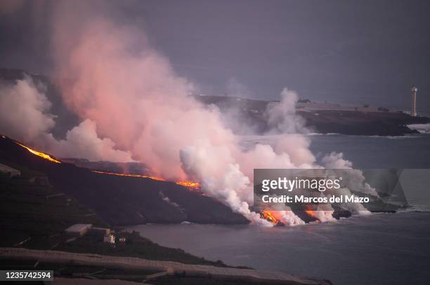 Lava reaching the sea producing a heavy smoke column. The volcano of Cumbre Vieja in the Canary Island of La Palma continues erupting lava after more...