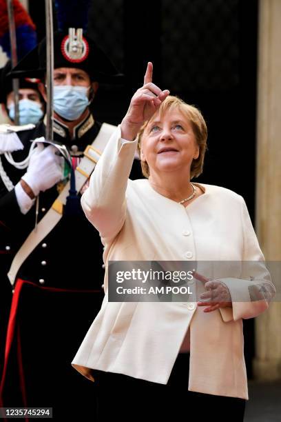 Italian Prime Minister Mario Draghi meets the German Chancellor Angela Merkel before their meeting at Palazzo Chigi, on October 7, 2021 in Rome,...