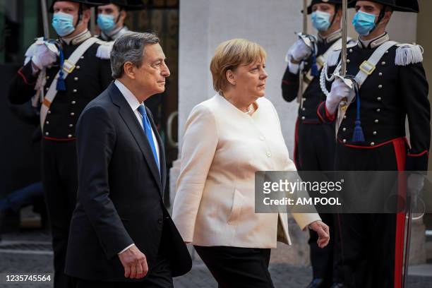 Italian Prime Minister Mario Draghi meets the German Chancellor Angela Merkel before their meeting at Palazzo Chigi, on October 7, 2021 in Rome,...