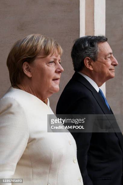 Italian Prime Minister Mario Draghi meets the German Chancellor Angela Merkel before their meeting at Palazzo Chigi, on October 7, 2021 in Rome,...