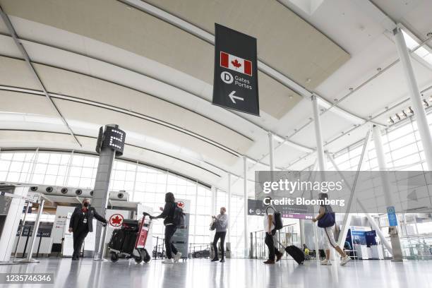 Travelers arrive at the Air Canada check-in area at Toronto Pearson International Airport in Toronto, Ontario, Canada, on Wednesday, Oct. 6, 2021....