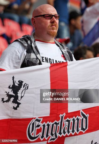 An England supporter cheers with his national flag prior to the quarter final football match of the FIFA women's football World Cup England vs France...