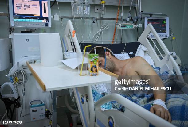 Covid-19 patient is pictured inside the intensive care unit of the "Pneumophysiology Institute Prof Dr Marius Nasta" in Bucharest, on October 7 amid...