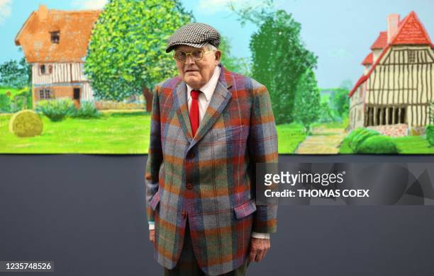 British painter David Hockney poses at the Orangerie museum in Paris, on October 7 in front of his painting "A year in Normandy", a 91-meter-long...