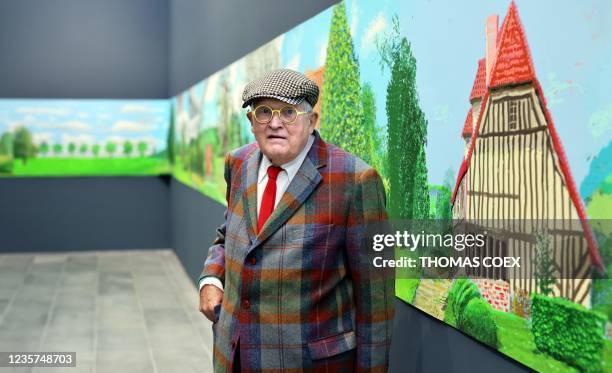 British painter David Hockney poses at the Orangerie museum in Paris, on October 7 in front of his painting "A year in Normandy", a 91-meter-long...