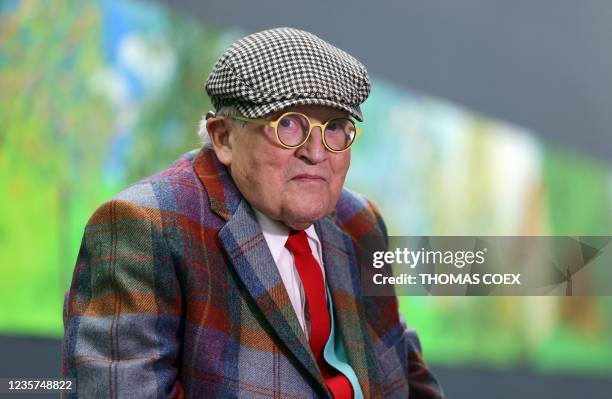 British painter David Hockney poses at the Orangerie museum in Paris, on October 7 in front of his painting "A year in Normandy", a 91-meter-long...