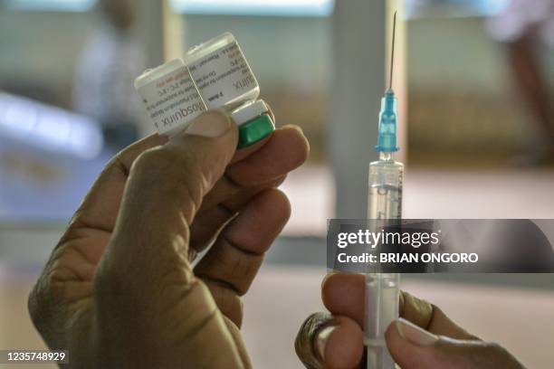Health worker prepares a malaria vaccination for a child at Yala Sub-County hospital, in Yala, Kenya, on October 7, 2021. - World Health Organization...