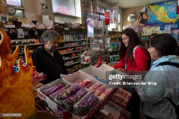 September 21, 2021: High school girls just off a bus crowd the counter at Stratford Market as owner Mahmod Alrihimi, left, rings up purchases on...