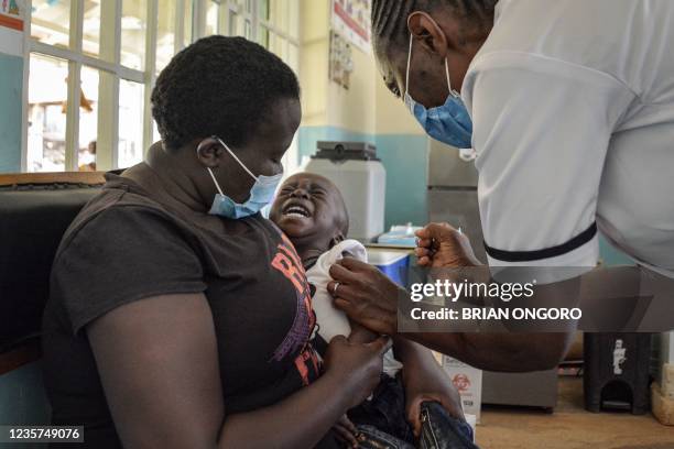 Child gets a malaria vaccination at Yala Sub-County hospital, in Yala, Kenya, on October 7, 2021. - World Health Organization approved using the...