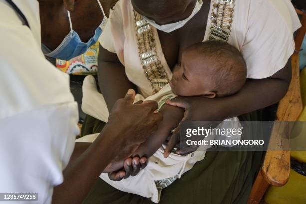 Child gets a malaria vaccination at Yala Sub-County hospital, in Yala, Kenya, on October 7, 2021. - World Health Organization approved using the...