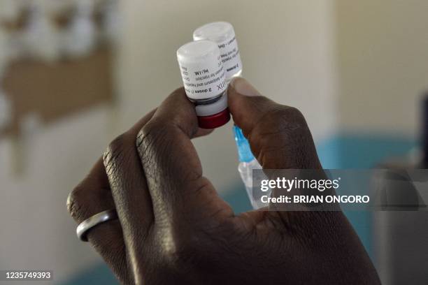 Health worker prepares a malaria vaccination for a child at Yala Sub-County hospital, in Yala, Kenya, on October 7, 2021. - World Health Organization...