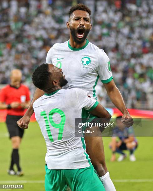 Saudi's forward Firas al-Buraikan cheers after scoring a goal during the 2022 Qatar World Cup Asian Qualifiers football match between Saudi Arabia...