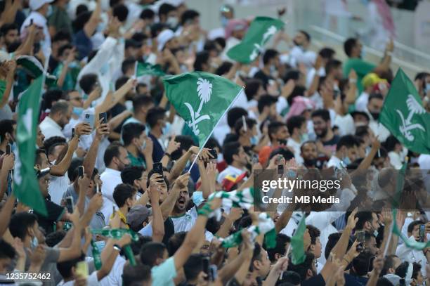 Saudi Arabian fans celebrate after scoring against Japan during the 2022 FIFA World Cup Qualifier match at King Abdullah Sports City on October 7,...