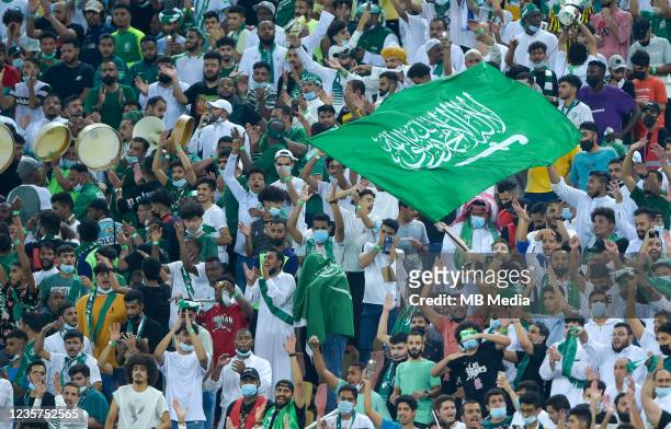 Saudi Arabian fans celebrate after scoring against Japan during the 2022 FIFA World Cup Qualifier match at King Abdullah Sports City on October 7,...