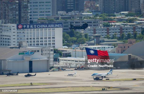 Military helicopters carrying tremendous Taiwan flags conduct a flyby rehearsal ahead of National Day celebration, near Taipei 101 , amid escalating...