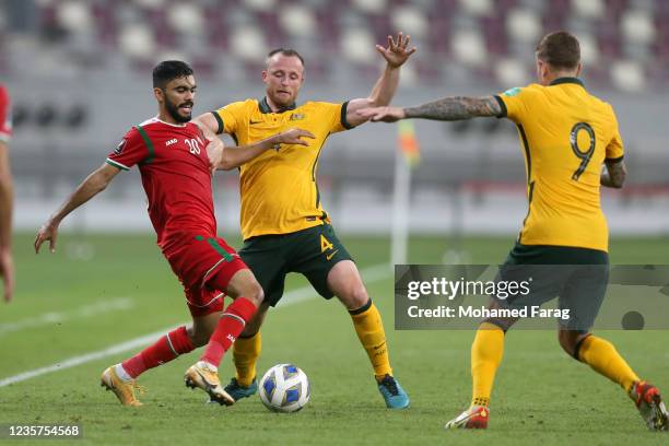 Ryan Grant of Australia and Salaah al-Yahyaei of Oman battle for the ball during the 2022 FIFA World Cup Qualifier match between Australia and Oman...