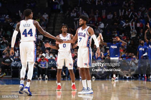 Paul Reed of the Philadelphia 76ers, Tyrese Maxey of the Philadelphia 76ers and Isaiah Joe of the Philadelphia 76ers react during a preseason game on...