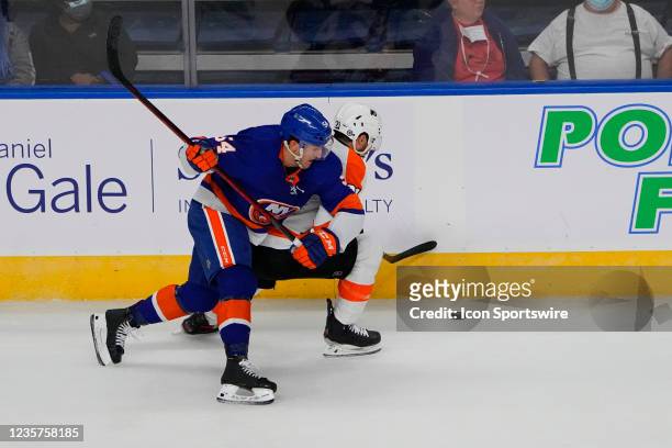 New York Islanders Center Cole Bardreau and Philadelphia Flyers Left Wing Scott Laughton battle for the puck during the first period of the...