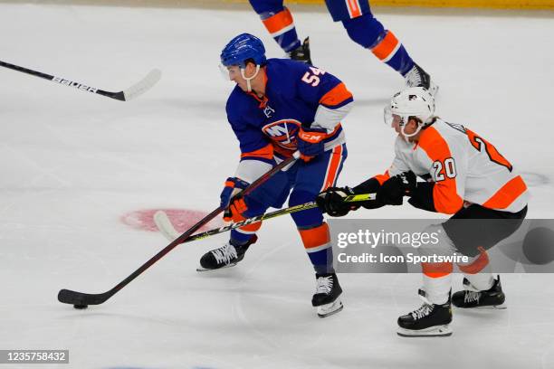 New York Islanders Center Cole Bardreau and Philadelphia Flyers Center Gerald Mayhew battle for the puck during the first period of the pre-season...