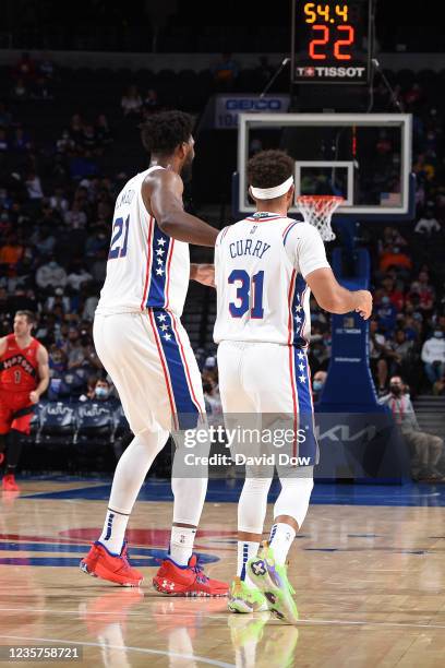 Joel Embiid of the Philadelphia 76ers and Seth Curry of the Philadelphia 76ers high-five during a preseason game on October 7, 2021 at Wells Fargo...